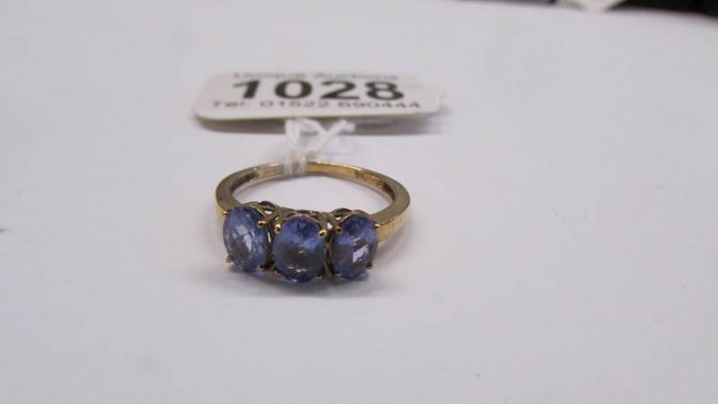 A 9ct yellow gold tanzanite three stone ring, size N, 2.1 grams. - Image 2 of 2