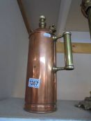 A vintage copper fire extinguisher.