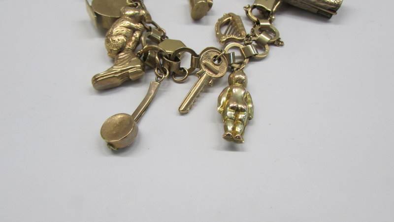 A 9ct gold charm bracelet, most charms marked, some unmarked but assured gold. 25 grams. - Image 2 of 3