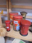 Five post/pillar box money boxes including one with clock and one brass.