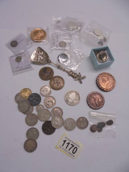 A mixed lot of old coins including silver.