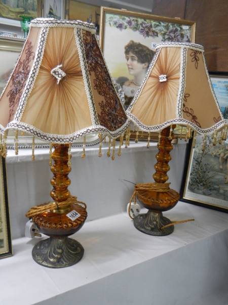 A pair of amber glass lamp bases.