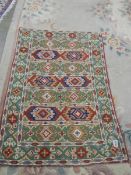 A 73 X 116 cm patterned rug.