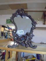 A metal framed art nouveau style mirror featuring cherubs.