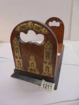 A 19th century walnut and brass extending book shelf.