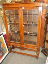 An Edwardian two door oak display cabinet, no key but in good condition, COLLECT ONLY.