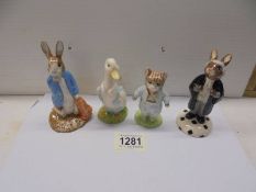 Four Beatrix Potter and Bunnikins figures.