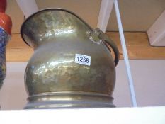 A brass coal scuttle.