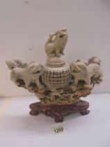 A large soapstone incense burner featuring lions.