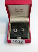 A pair of oval sapphire and diamond white gold earrings.