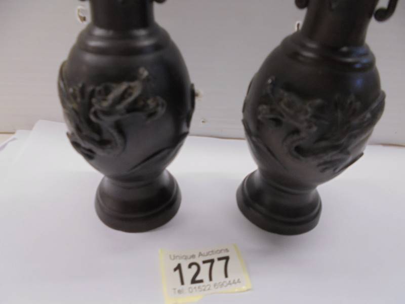 A pair of bronze vases with applied dragons, 17 cm tall. - Image 2 of 2