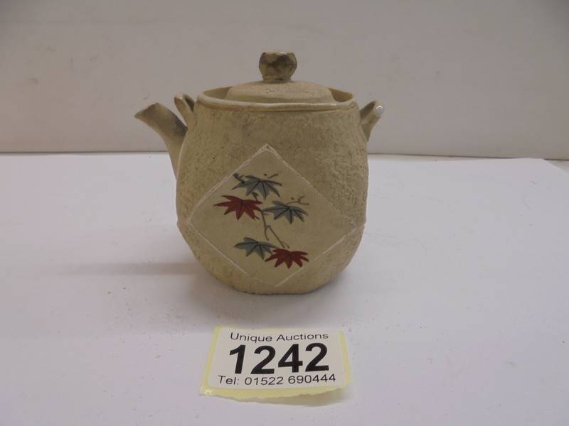 A miniature Oriental porcelain teapot.