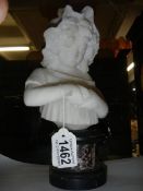 An albaster bust on a plinth.
