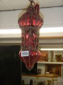 A red glass and metal porch light.