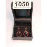 A pair of 9ct gold earrings set red stones.