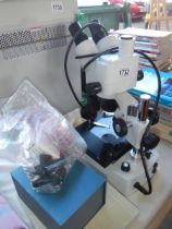 A Muller Lab bioligical microscope with accessories, camera and slides. COLLECT ONLY.