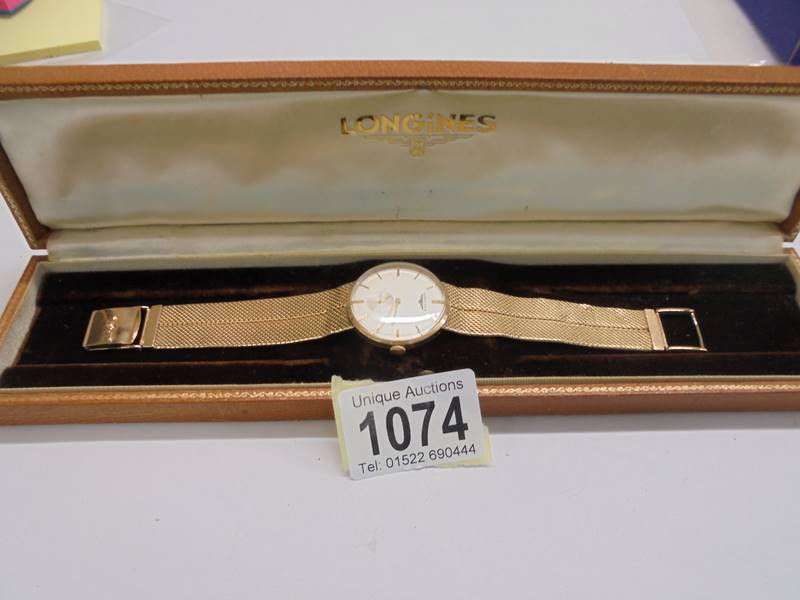 A vintage cased Longines 9ct gold wrist watch.