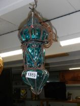 A turquoise glass and metal porch light.
