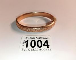 A 9ct gold engraved bangle, 10.7 grams.