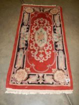 A small rug, 130 x 60 cm.