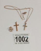 A 9ct gold cross on chain, another 9ct gold cross and a pendant.