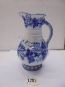 A 19th century blue and white jug with lozenge mark on base.