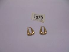 A pair of 9ct gold ear hoops.