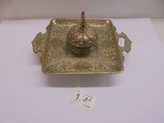 A Persian style brass inkwell.,