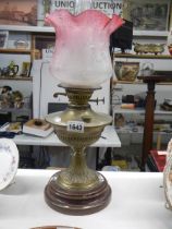 A brass oil lamp with pink tulip shade, COLLECT ONLY.