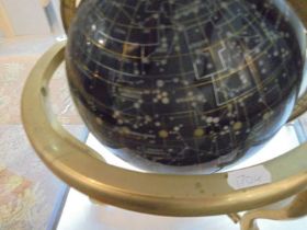 A gem stone celestial globe on brass stand.
