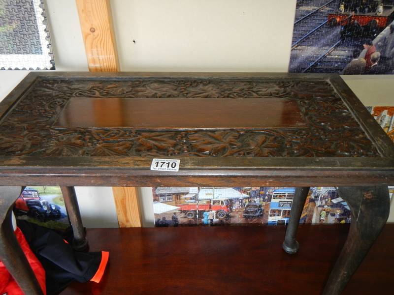 A carved top table on Queen Anne style legs, COLLECT ONLY.