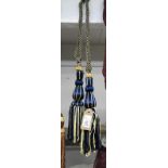 A pair of blue and gold curtain tie backs with tassel