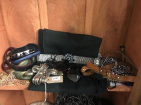 A selection of scarves, belts and sunglasses