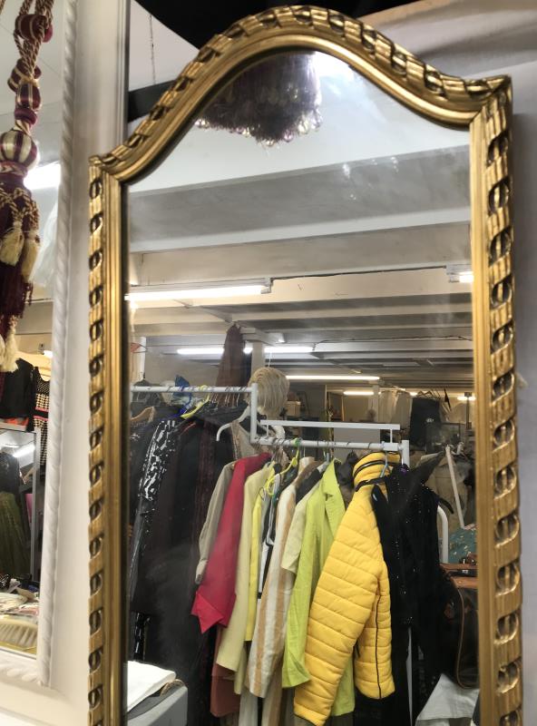 A long rectangle mirror with an arched top