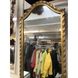 A long rectangle mirror with an arched top