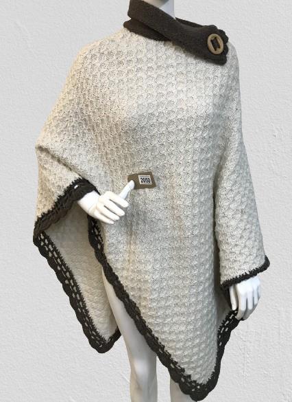 A Vintage Chunky Poncho shawl with brown trim and button detail to neck.