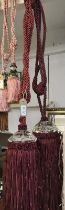 A pair of red wine curtain tie backs with gem style embellishment and tassels