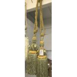 One pair of green with gold embellishment curtain tie backs with tassels