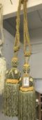 One pair of green with gold embellishment curtain tie backs with tassels