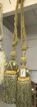 One pair of green with gold embellishment curtain tie backs with tassels