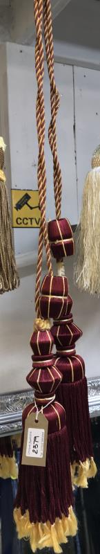One pair of red wine and gold curtain tie backs with tassels