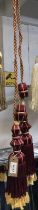 One pair of red wine and gold curtain tie backs with tassels