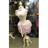 A mannequin with pink netting and embellishments