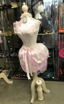 A mannequin with pink netting and embellishments