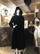A Lovely quality black full length velvet coat with hood. Hidden button placket. Designer Four
