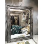 A large rectangle mirror with silver effect frame