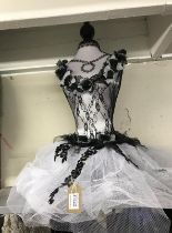 A mannequin with black netting and embellishments, No stand
