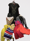 A large suitcase full of garments including Planet, Oasis, monsoon, Next and Warehouse. All