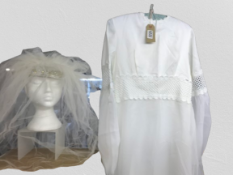 A lovely white wedding dress with veil. both with flower embellishments