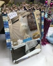 A small rectangle mirror with flower embellishment